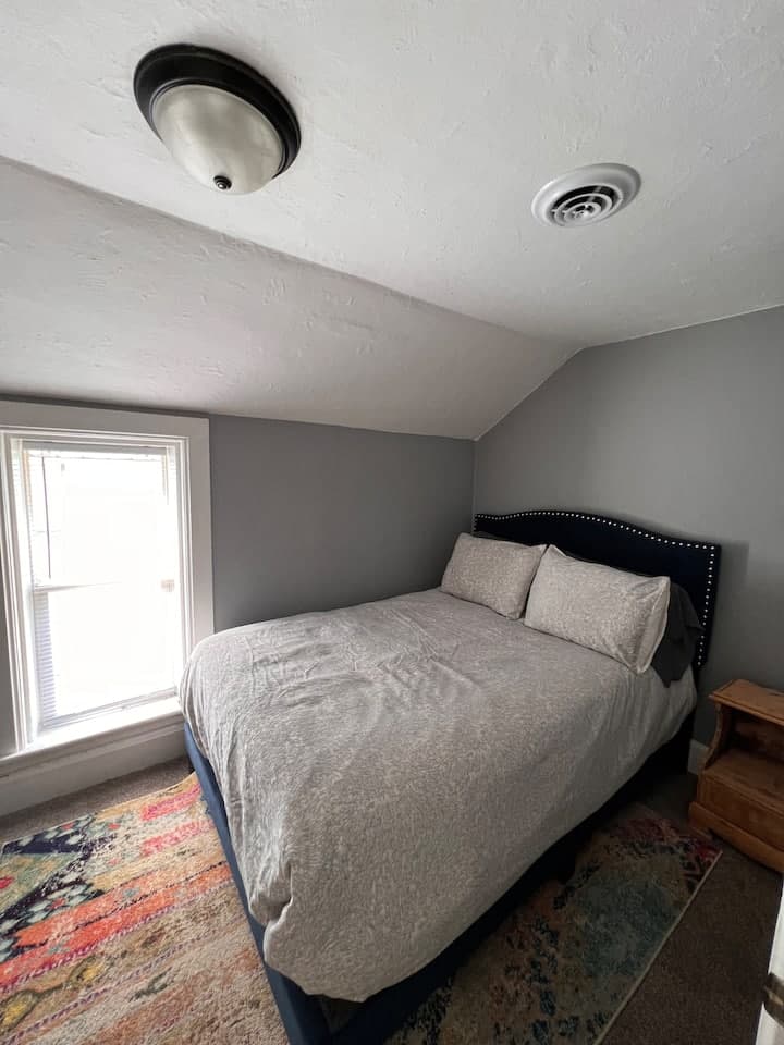 Bedroom with a window at Close to Downtown Apartment