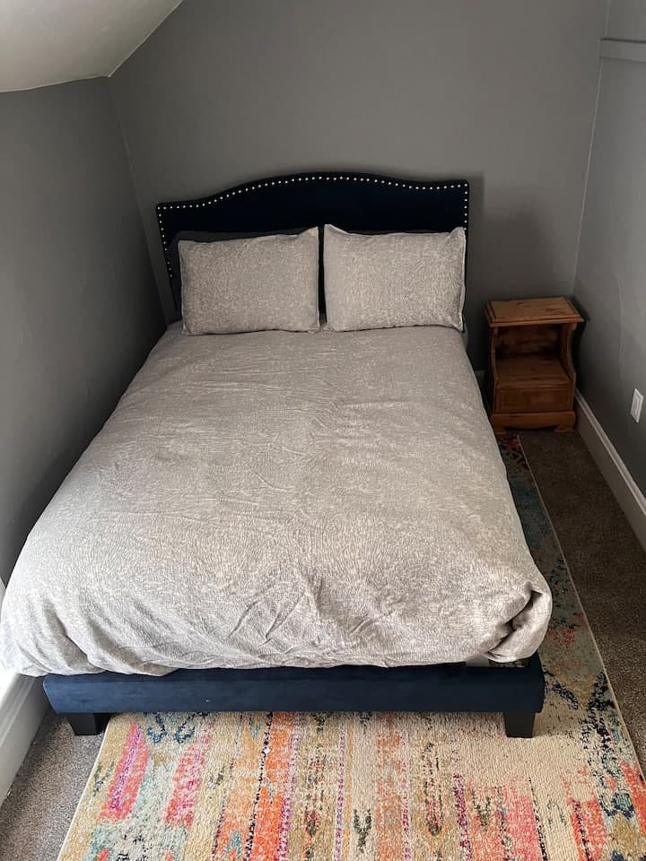 Bedroom with a navy headboard