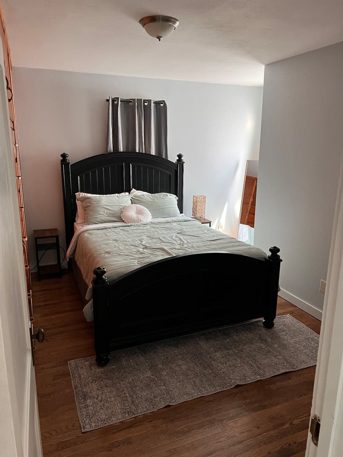 Second bedroom with a black wood bed in Sparta Renovated 2-Bedroom