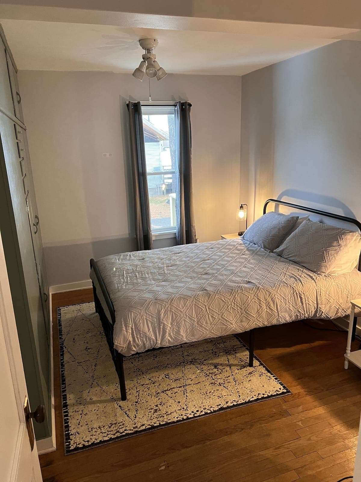 Bedroom with a queen bed in the lower Sparta apartment